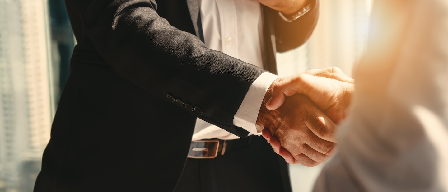 Business handshake symbolizing Aero's acquisition of Kable Product Services