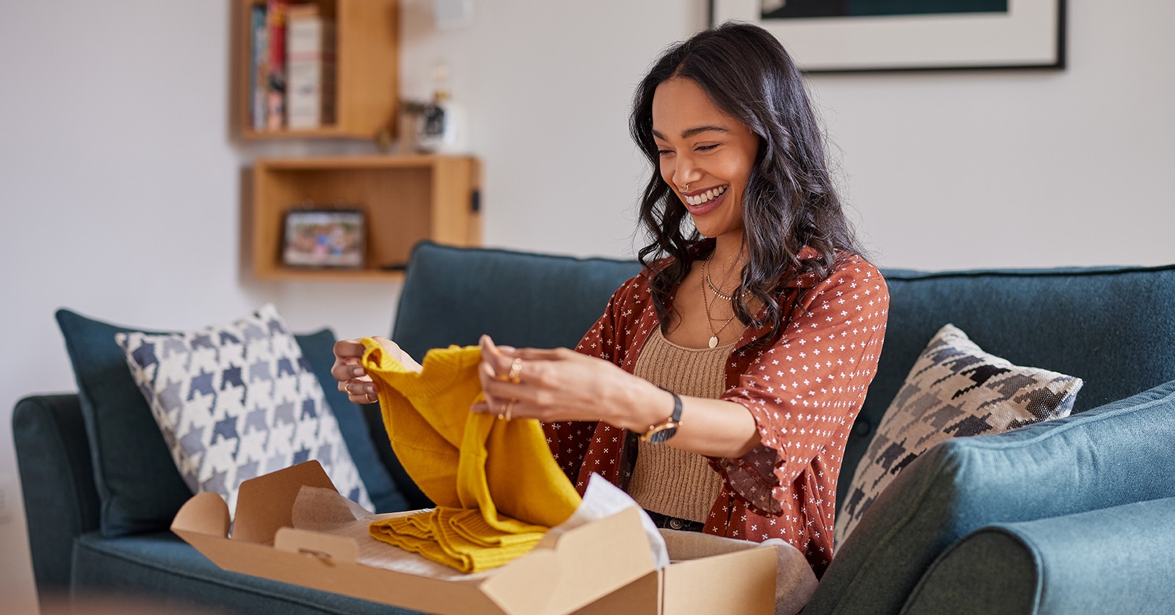 Woman happily unboxing an online order at home — representing custom kitting and assembly services for ecommerce fulfillment